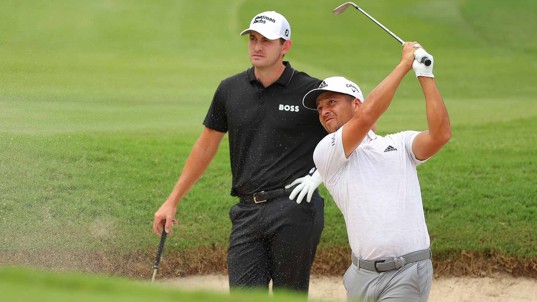 Patrick Cantlay watches Xander Schauffele hit a shot from a bunker at East Lake.