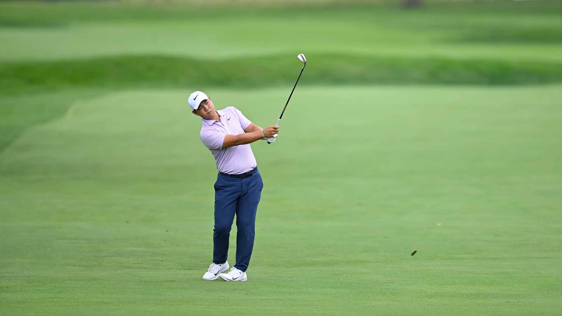 tom kim hits a wedge at the 2024 rocket mortgage classic